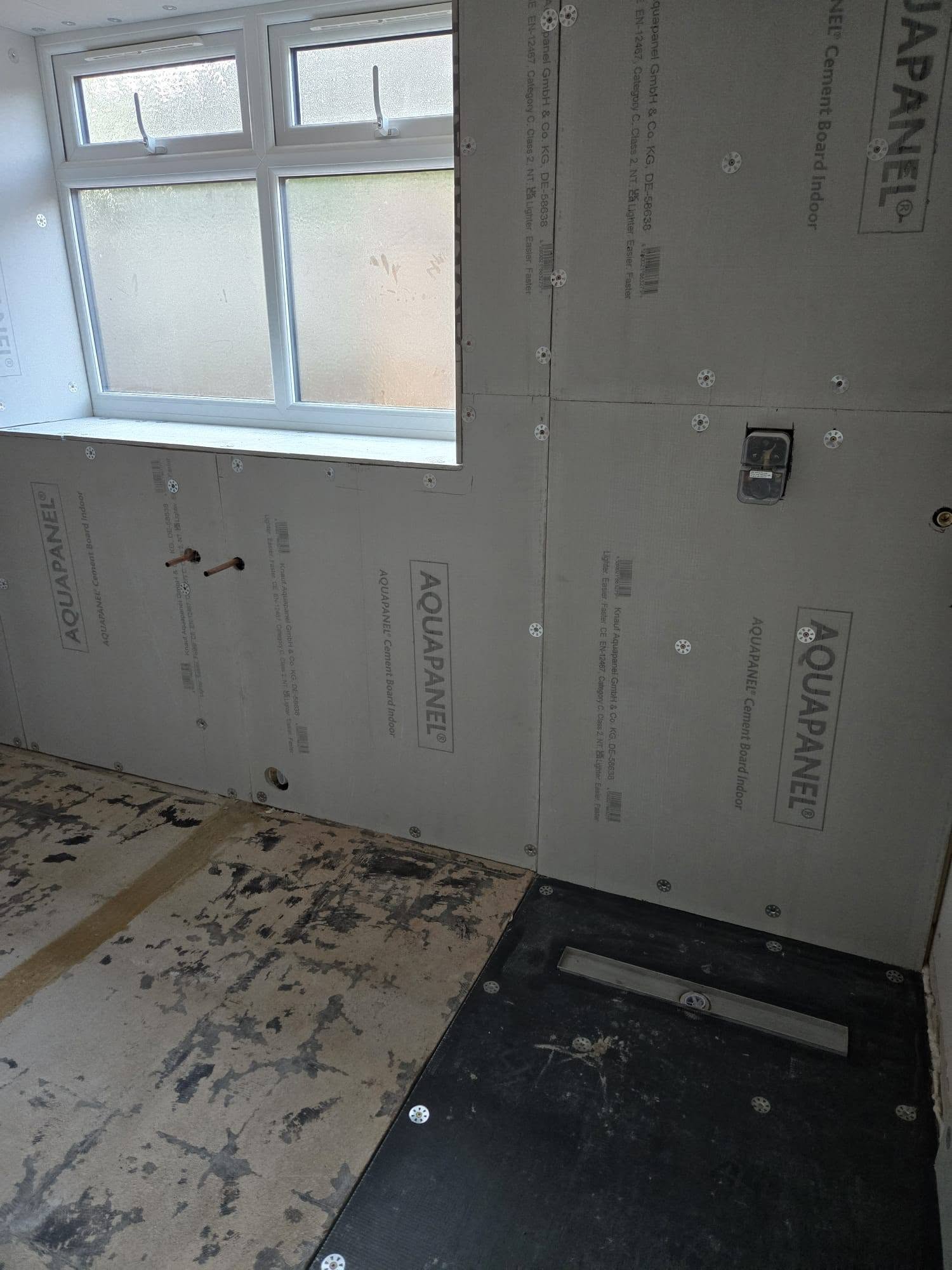 Wet room base: Tray and linear drain set in place.